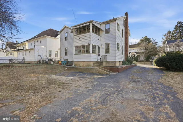 a large white building with a white bed in front of it