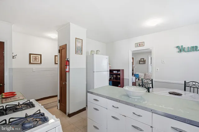 a kitchen with sink and refrigerator
