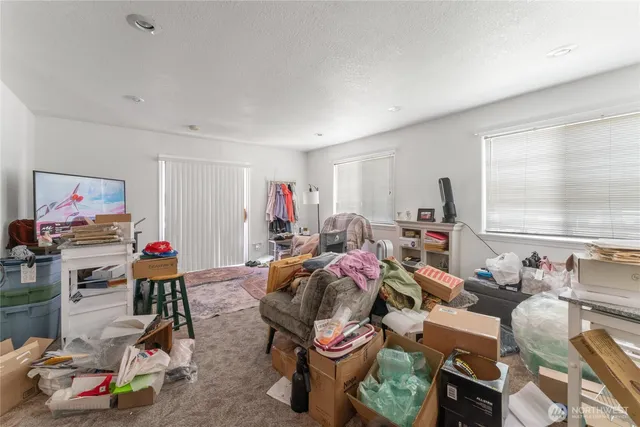 a living room with furniture a flat screen tv and a window