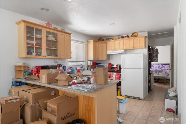 a kitchen with a refrigerator and a sink