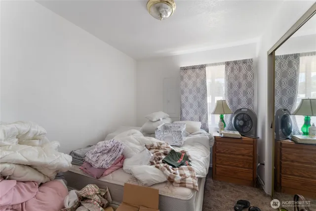 a bedroom with bed and wooden floor