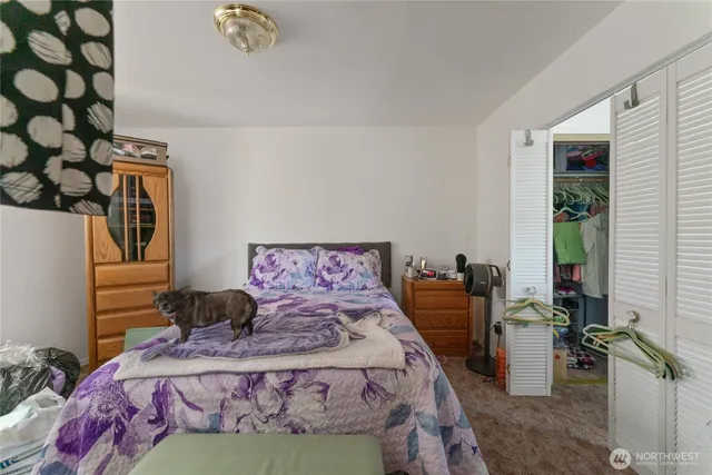 a bedroom with bed and a window