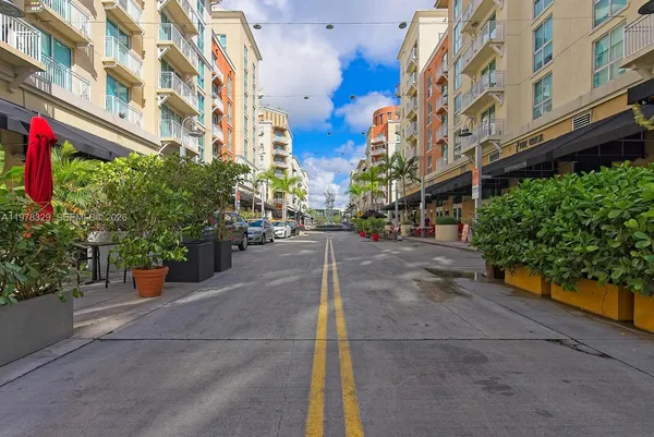 a view of a street with tall buildings