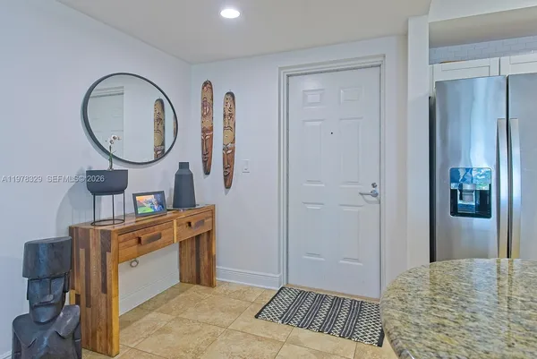 a bed room with a bed mirror and a table