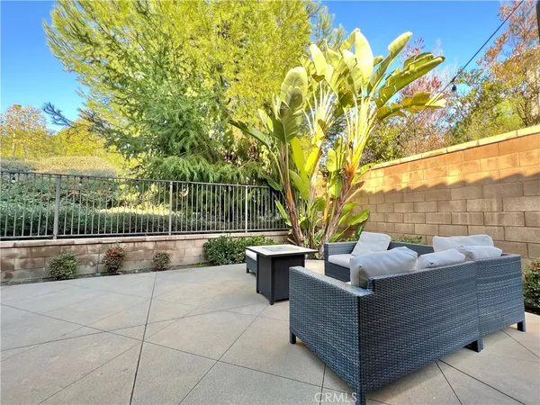 a view of a patio with couches and a table and chairs