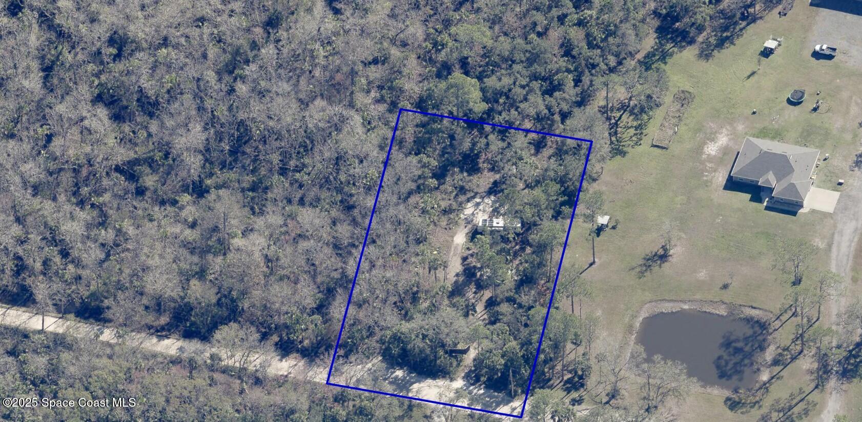 a aerial view of a house with a yard