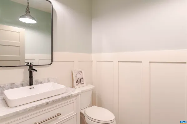 a bathroom with a sink a toilet and vanity