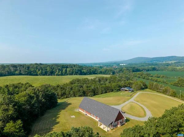 an aerial view of a house having swimming pool patio and lake view