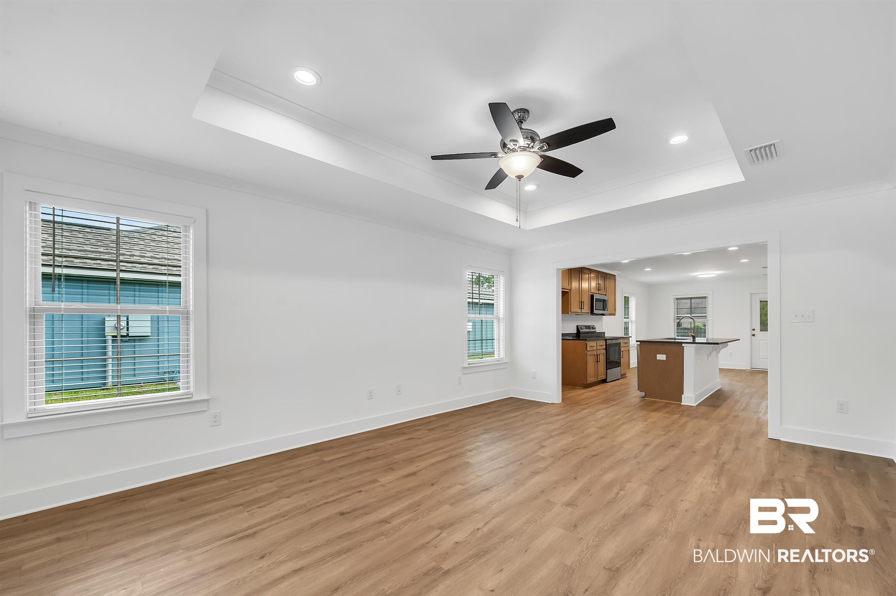22045 8th Street Silverhill, AL 36576 - Photo 8 of 39 Living area with a raised ceiling, ornamental molding, light wood-style floors, ceiling fan, and recessed lighting