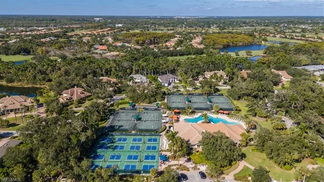 an aerial view of a house with a yard and large trees