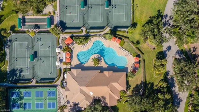 an aerial view of a house with a yard and lake view