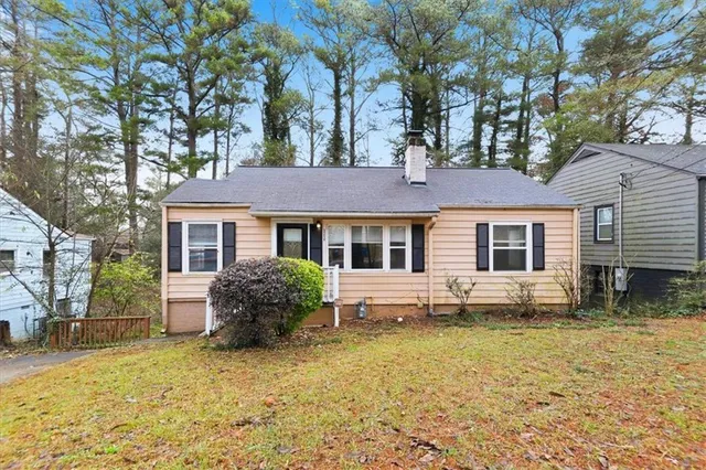 a front view of house with yard outdoor seating and barbeque oven