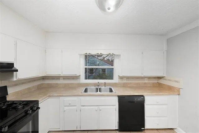 a kitchen with a refrigerator a sink and a stove