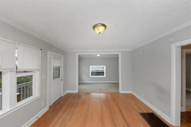 wooden floor in an empty room with a window