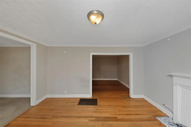 a view of a room with wooden floor
