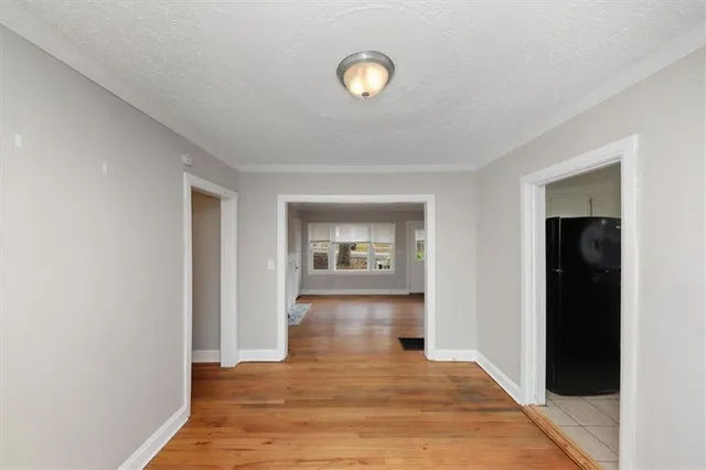 a kitchen with granite countertop a sink a stove and cabinets