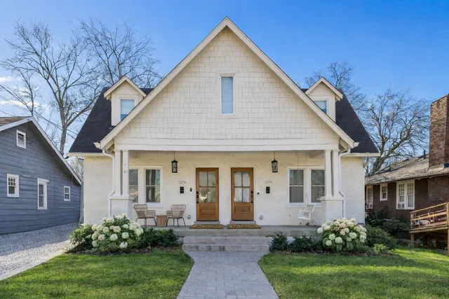 a front view of a house with a garden and plants