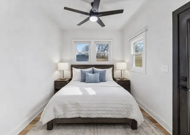 a bedroom with a bed and a chandelier