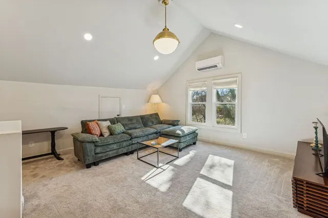 a spacious bedroom with a bed and dresser