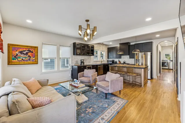 a living room with fireplace furniture and a wooden floor