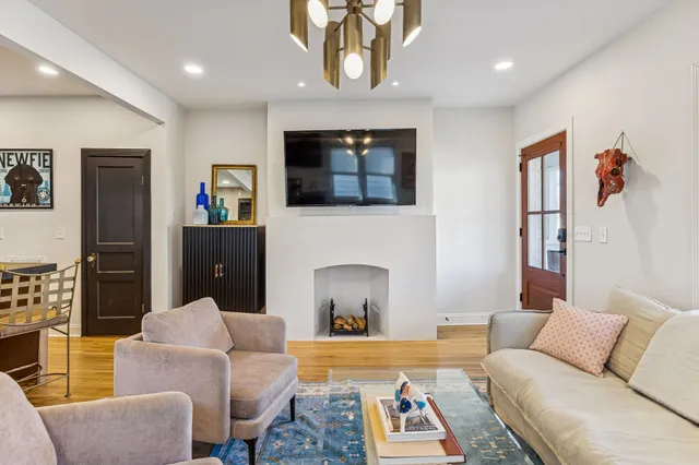 a living room with furniture and a fireplace