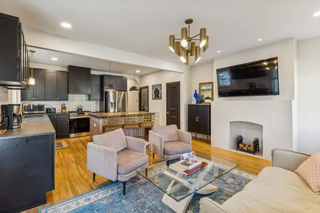 a living room with fireplace furniture and a flat screen tv