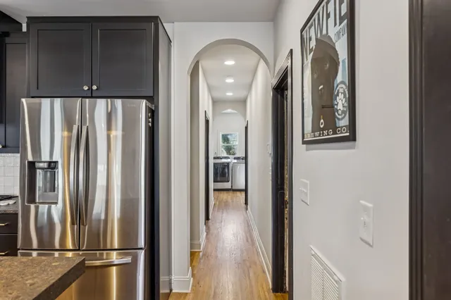 a view of a kitchen with a refrigerator and cabinets