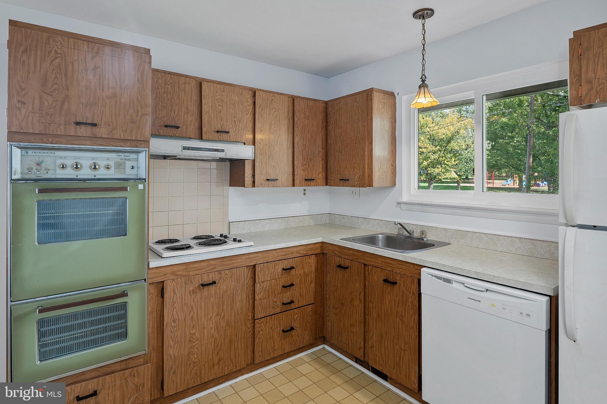 3947 Setonhurst Road Baltimore, MD 21208 - Photo 10 of 30 a kitchen with a sink stove and cabinets