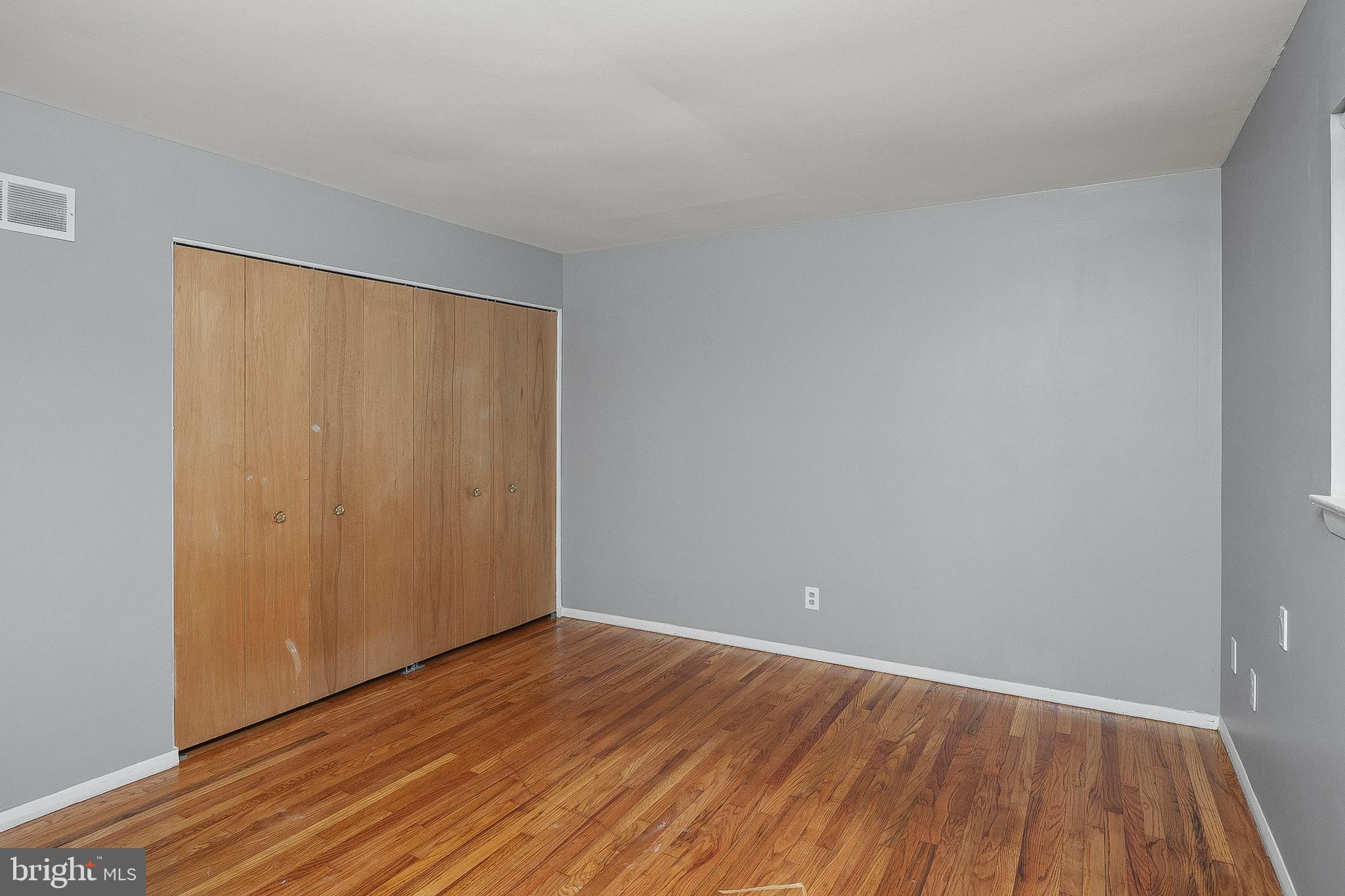 3947 Setonhurst Road Baltimore, MD 21208 - Photo 13 of 30 a view of an empty room with wooden floor and a window