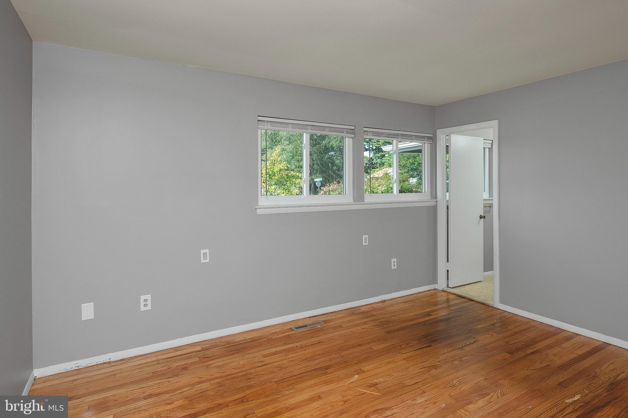 3947 Setonhurst Road Baltimore, MD 21208 - Photo 14 of 30 an empty room with wooden floor and windows