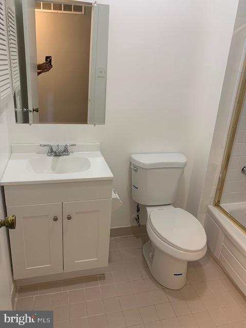 3947 Setonhurst Road Baltimore, MD 21208 - Photo 19 of 30 a white toilet sitting next to a bathroom sink