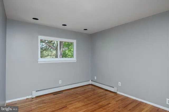 a view of a room with wooden floor and window