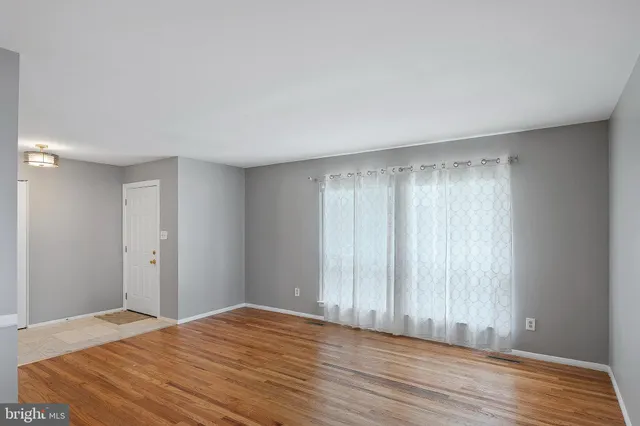 a view of room with window and wooden floor