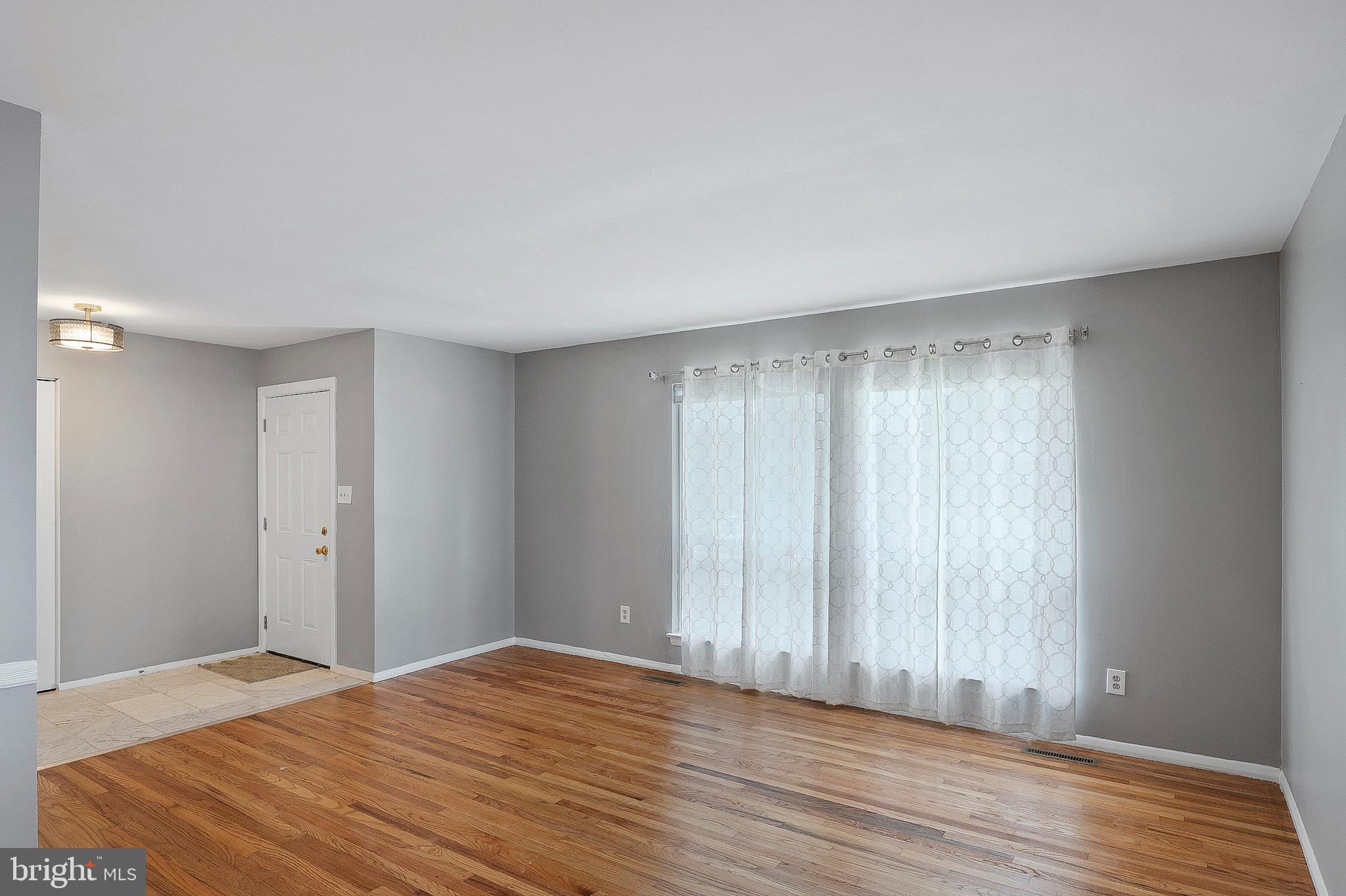 3947 Setonhurst Road Baltimore, MD 21208 - Photo 3 of 30 a view of room with window and wooden floor