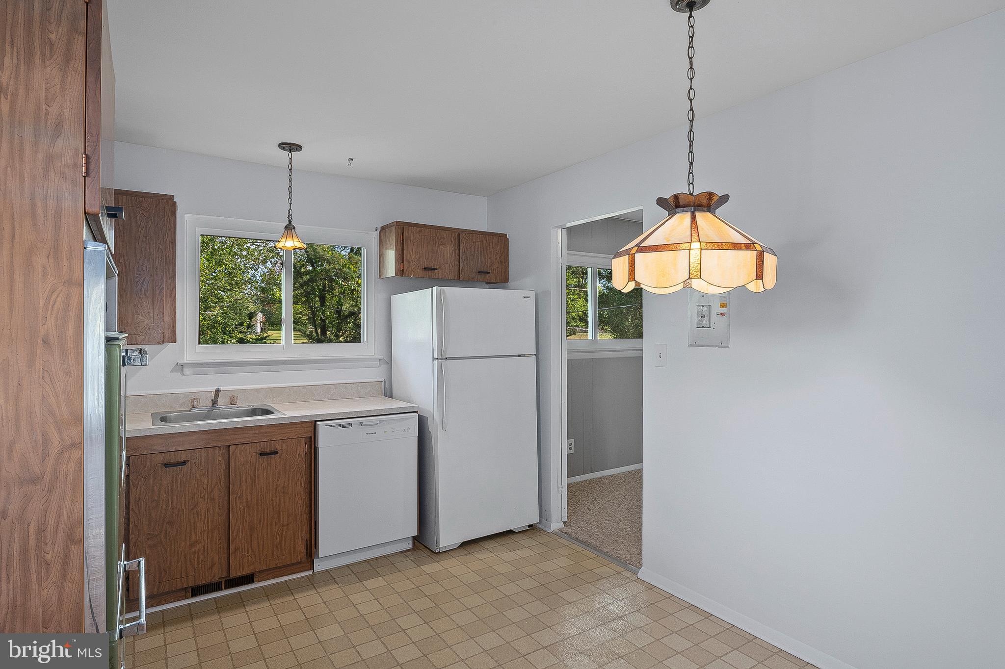 3947 Setonhurst Road Baltimore, MD 21208 - Photo 8 of 30 a kitchen with stainless steel appliances a refrigerator a sink a center island and a stove