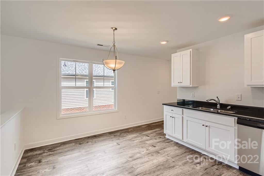 1704 Mooresville Road Salisbury, NC 28147 - Photo 4 of 9 a kitchen with granite countertop a sink a window and cabinets