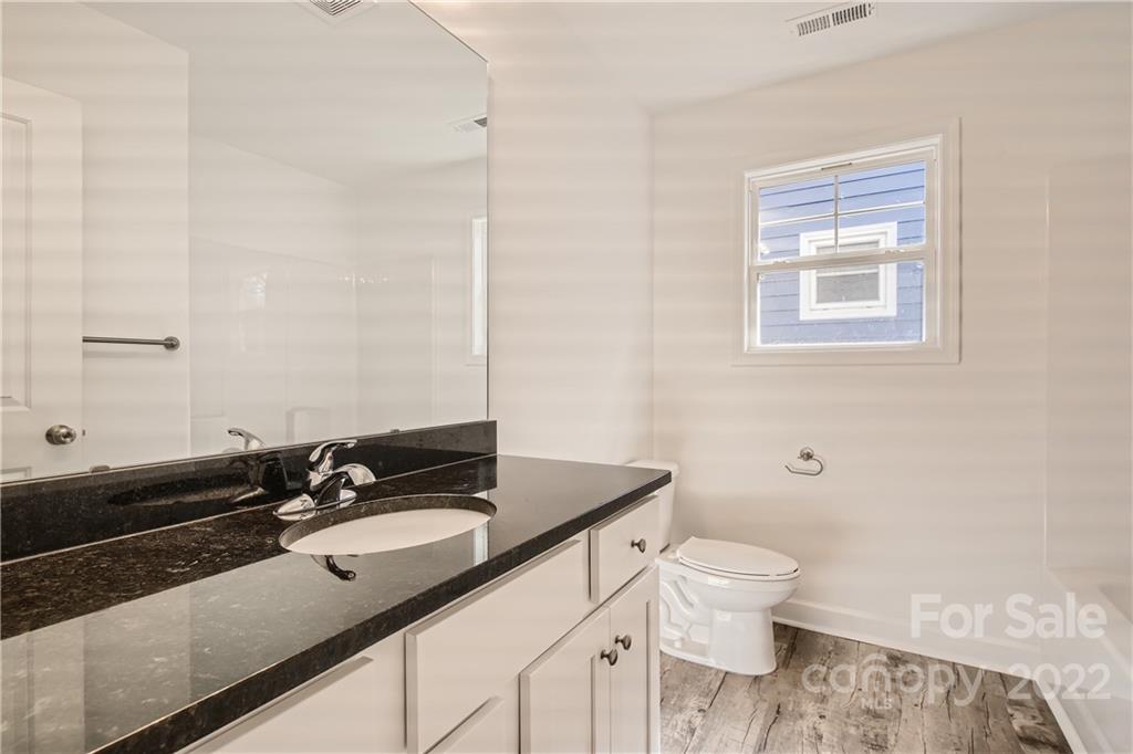 1704 Mooresville Road Salisbury, NC 28147 - Photo 7 of 9 a bathroom with a sink a toilet and a mirror