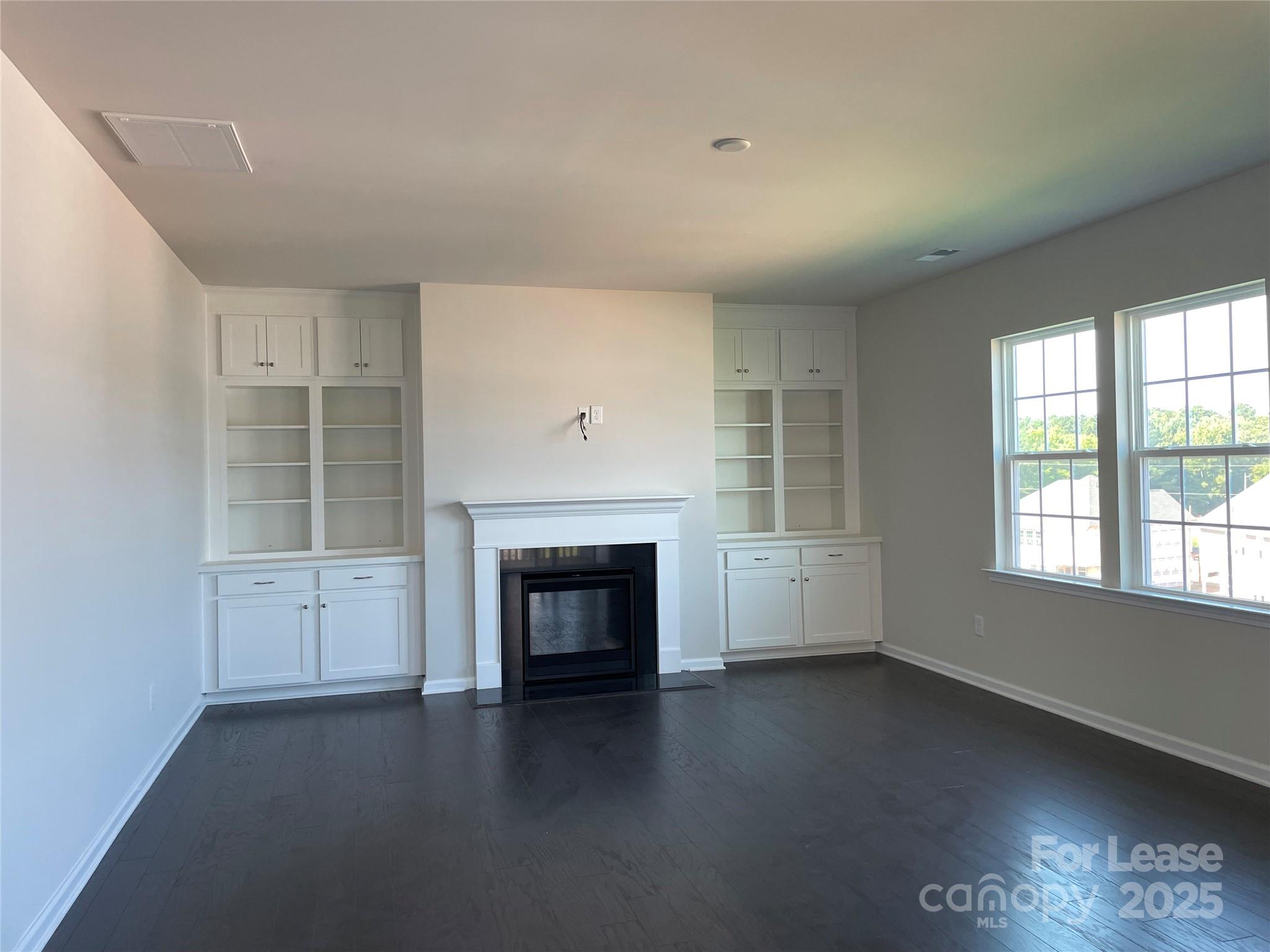17618 Snug Harbor Road, Unit LOT75 Charlotte, NC 28278 - Photo 2 of 33 an empty room with windows and fireplace