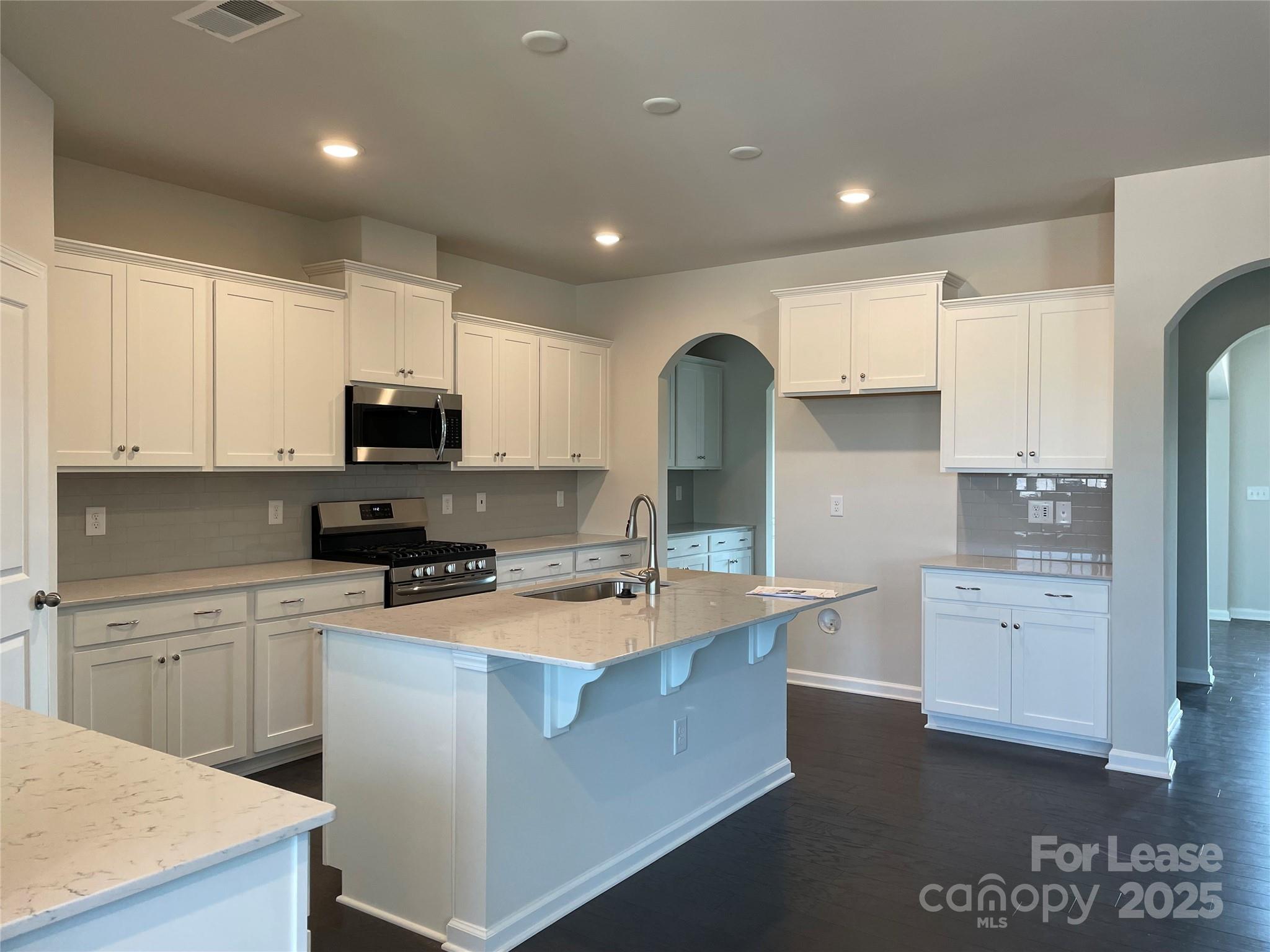 17618 Snug Harbor Road, Unit LOT75 Charlotte, NC 28278 - Photo 5 of 33 a kitchen with white cabinets appliances and sink