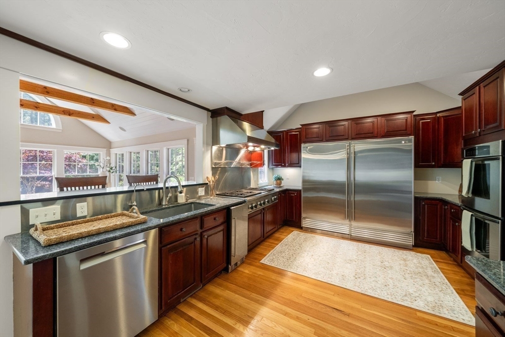 49 Walpole Street Dover, MA 02030 - Photo 9 of 40 a kitchen with stainless steel appliances granite countertop a sink and wooden cabinets
