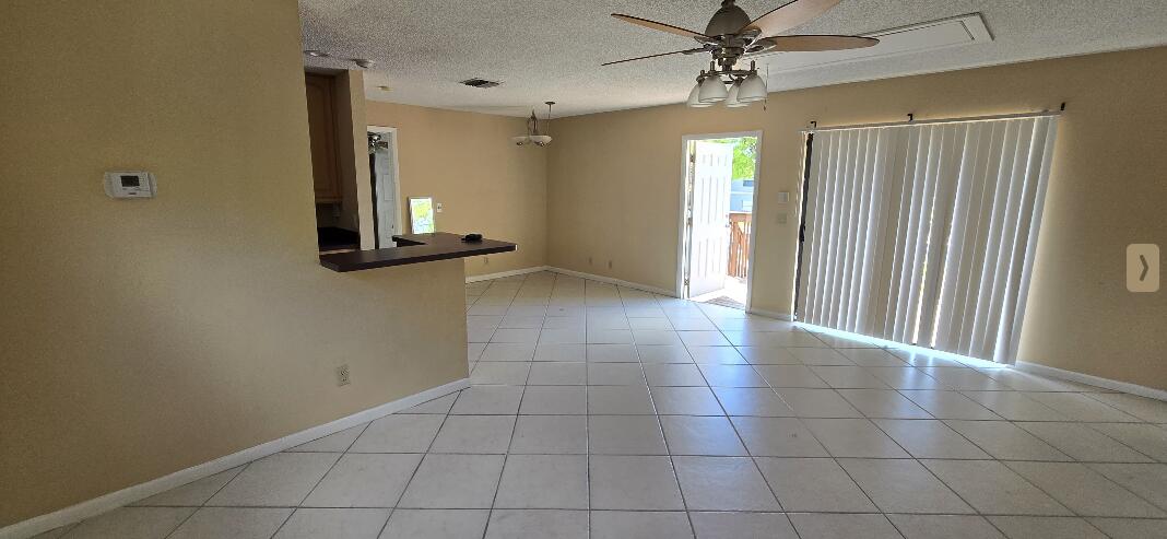1 Crossings Circle, Unit F Boynton Beach, FL 33435 - Photo 3 of 11 a view of a hallway with chandelier and entryway