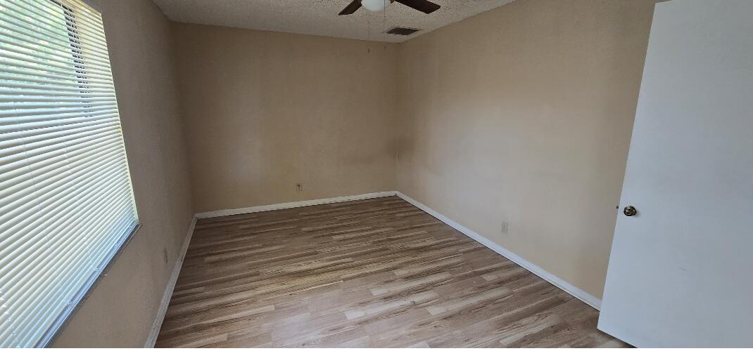 1 Crossings Circle, Unit F Boynton Beach, FL 33435 - Photo 7 of 11 a view of a room with wooden floor and staircase