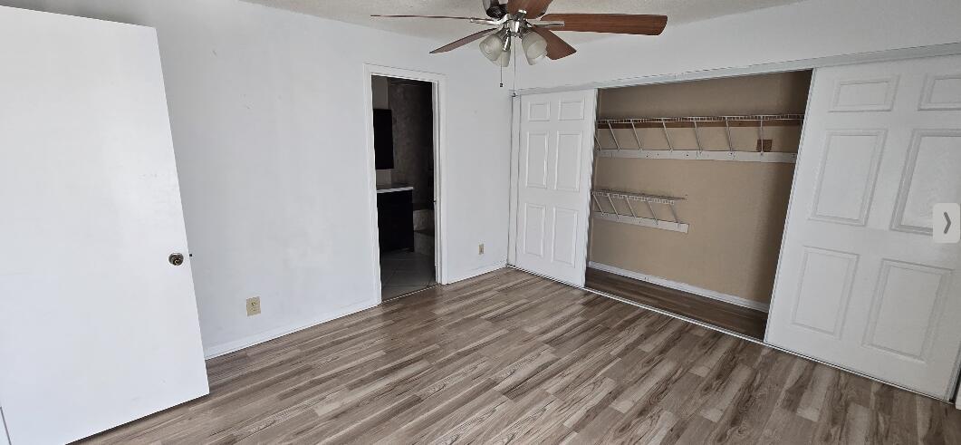 1 Crossings Circle, Unit F Boynton Beach, FL 33435 - Photo 8 of 11 an empty room with wooden floor closet and windows