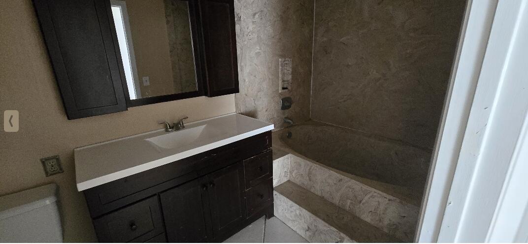 1 Crossings Circle, Unit F Boynton Beach, FL 33435 - Photo 10 of 11 a bathroom with a sink and a mirror