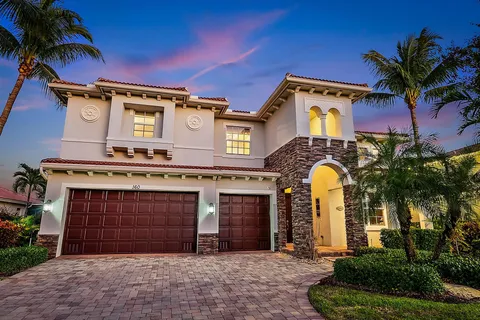a view of a house with a yard and potted plants