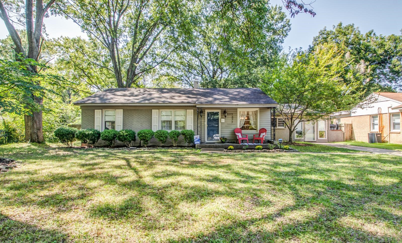 1377 Marcia Road Memphis, TN 38117 - Photo 1 of 24 a view of a house with a big yard and large trees