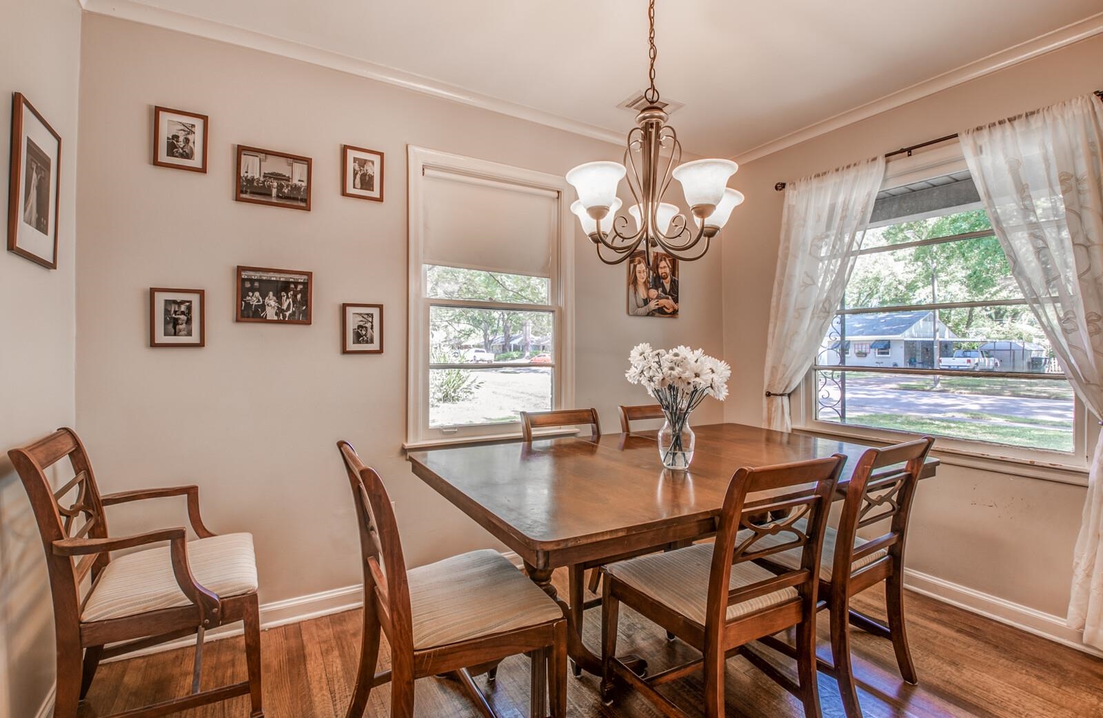 1377 Marcia Road Memphis, TN 38117 - Photo 6 of 24 a view of a dining room with furniture a chandelier and wooden floor