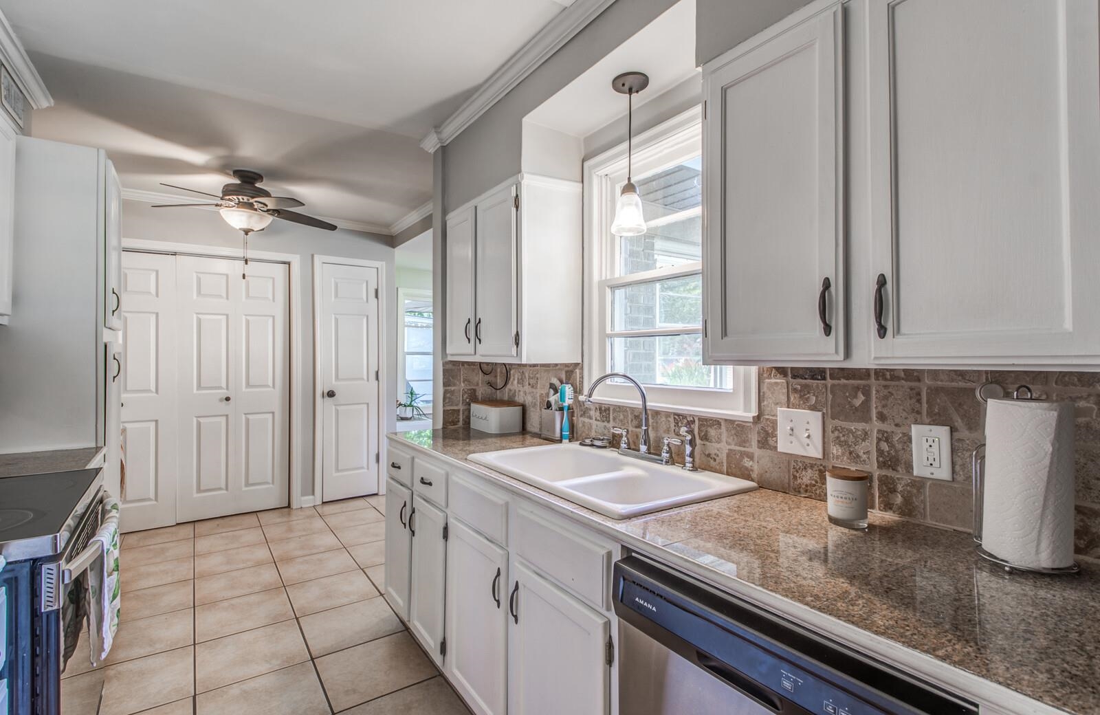 1377 Marcia Road Memphis, TN 38117 - Photo 7 of 24 a kitchen with a sink and a refrigerator