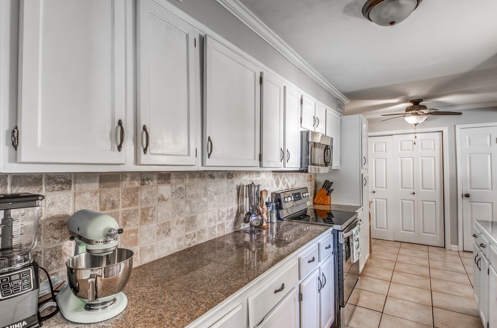 1377 Marcia Road Memphis, TN 38117 - Photo 8 of 24 a kitchen with stainless steel appliances granite countertop a sink and cabinets