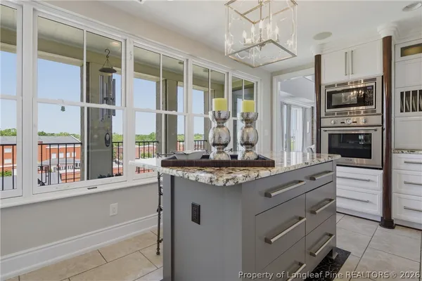 a kitchen with stainless steel appliances granite countertop a stove and a refrigerator
